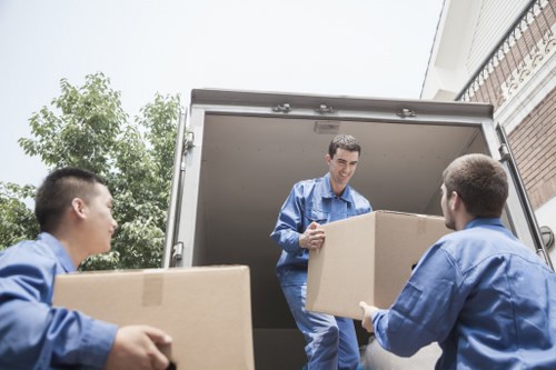Man with van loading furniture in Barnes near residential streets