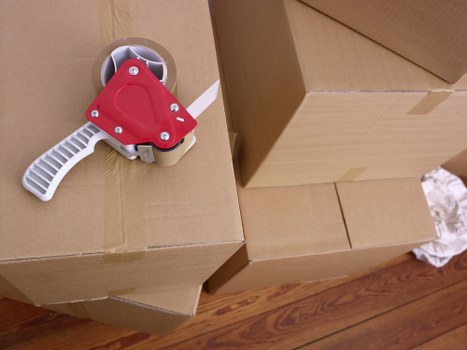 Packed office equipment and furniture ready for transport in Barnes